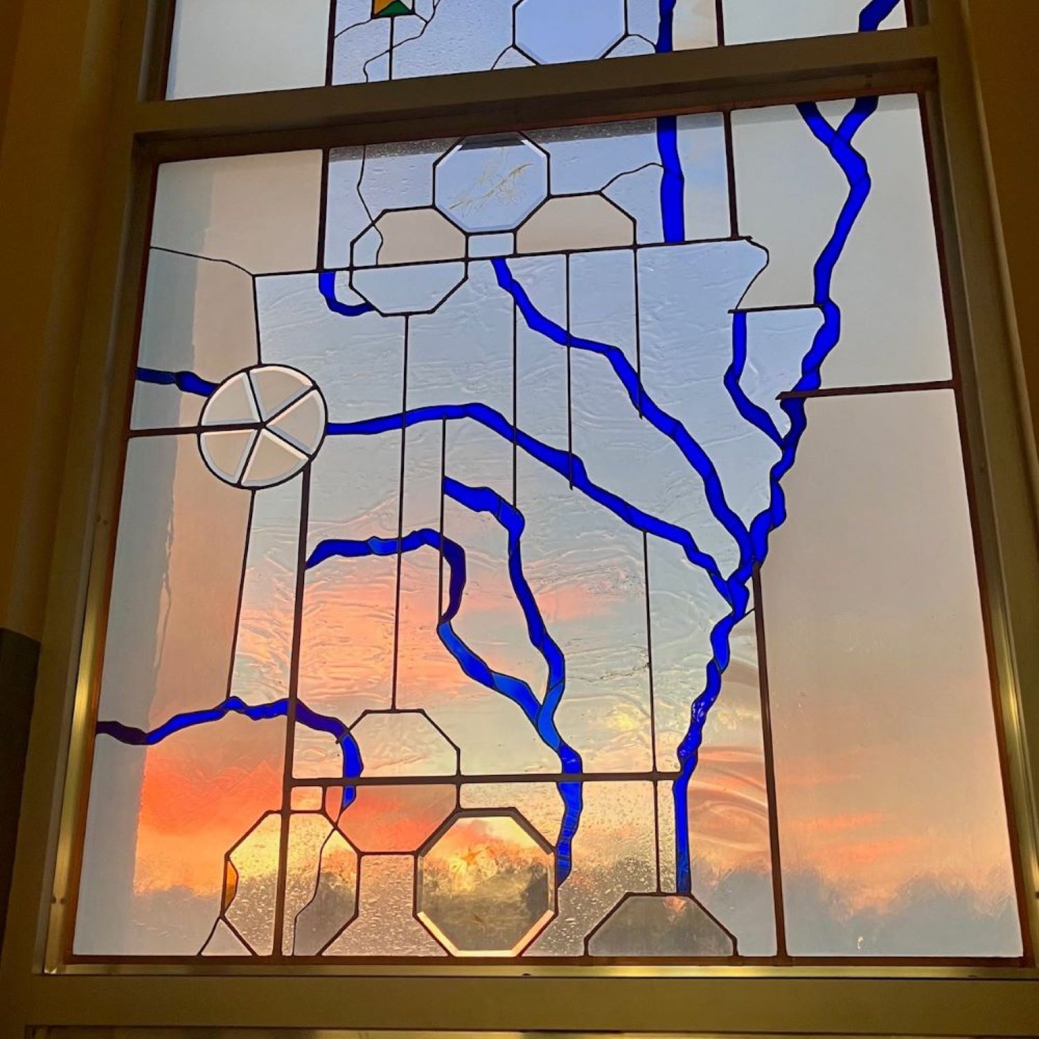 Sunset behind genealogy stained glass window