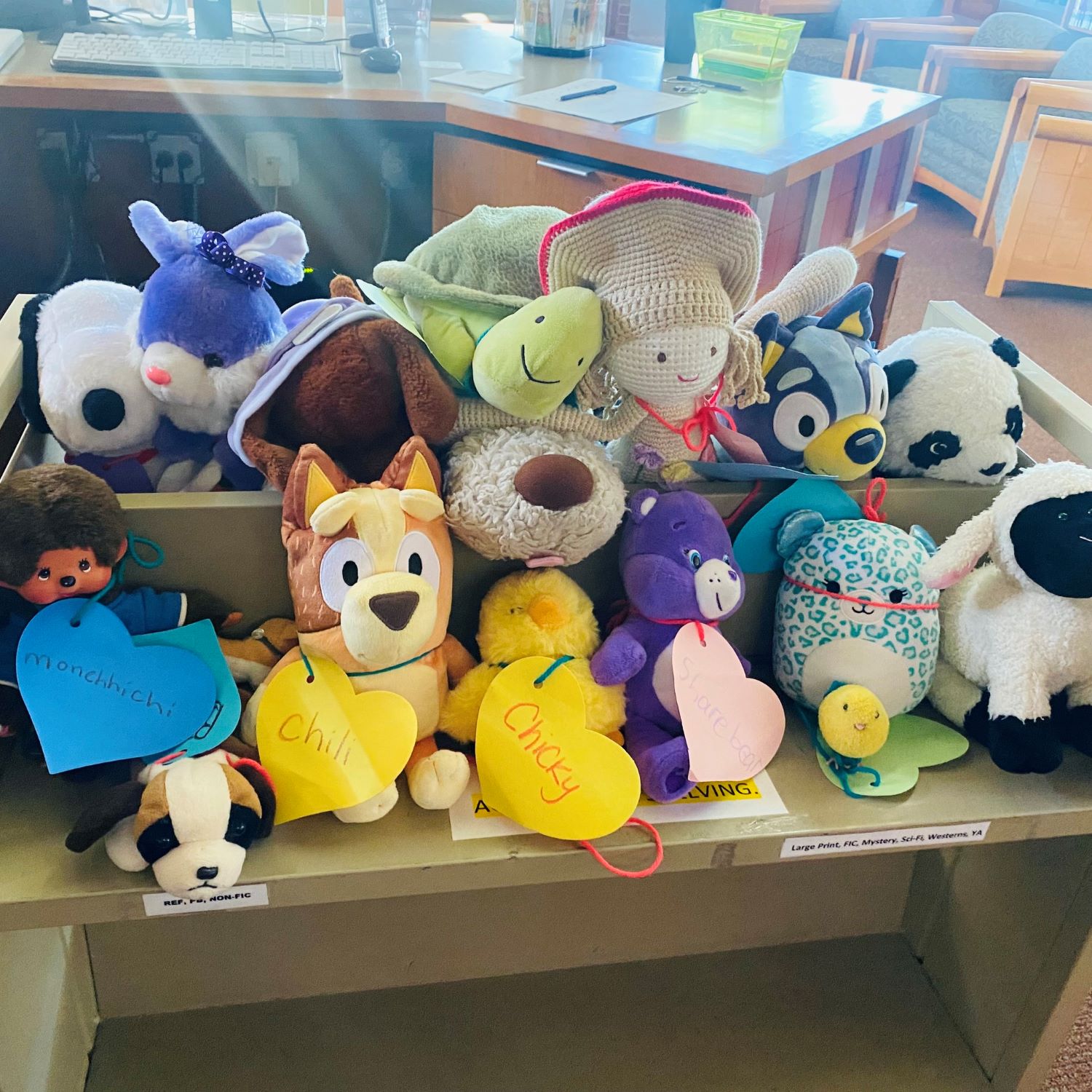 stuffed animals on a book cart