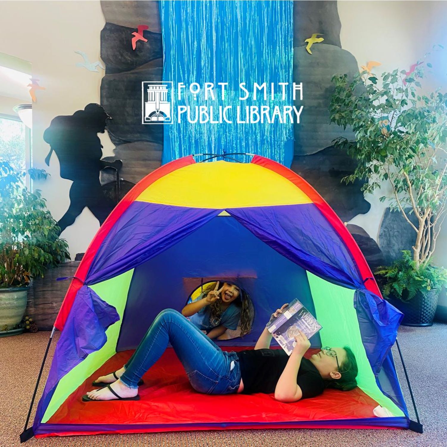 young adults reading in tent