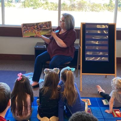 Mrs. Melanie reading at storytime