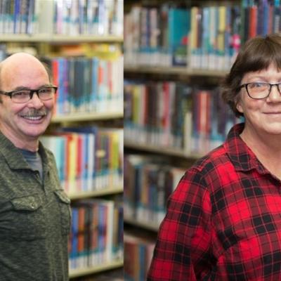 photograph of Jon and Mae Wellnitz in front of book shelves at the library