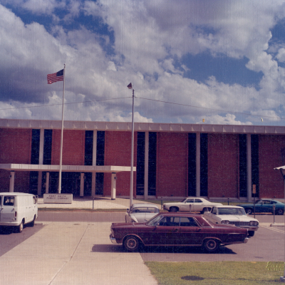 Photo of the 8th street library with vintage cars