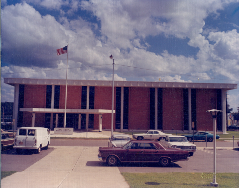 Photo of the 8th street library with vintage cars