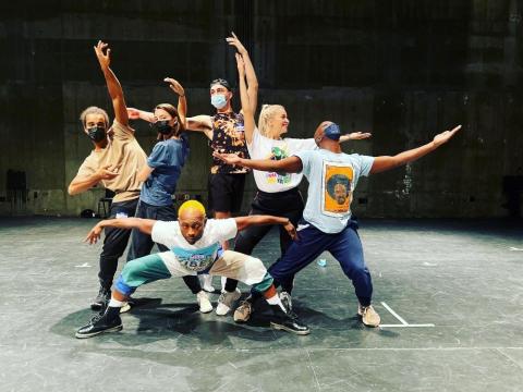 rooted movement dancers pose on stage