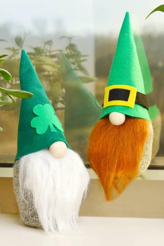 Two sock gnomes. One with a white beard with a shamrock on it and the other with a red beard with a belt on it. 