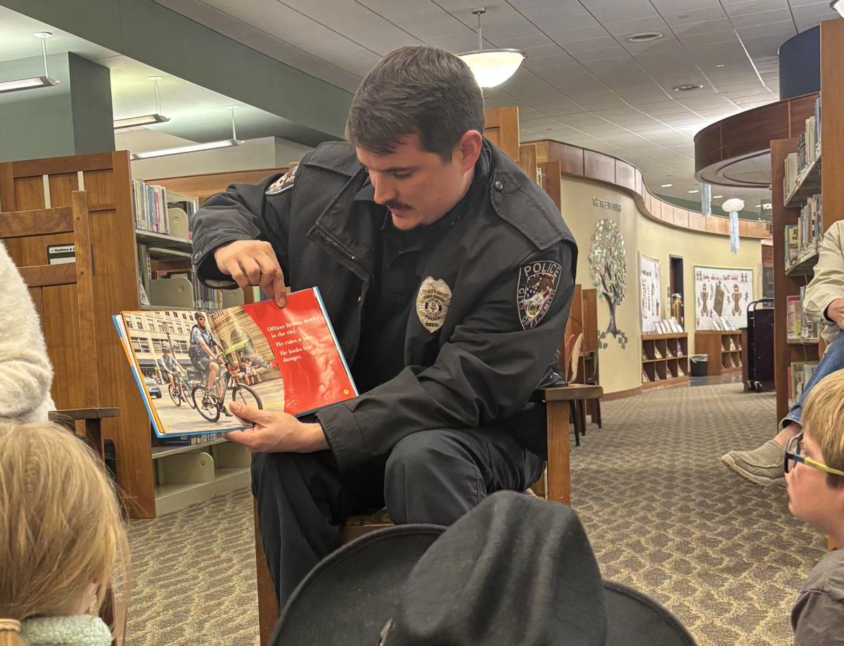 police officer reading a children's book at storytime