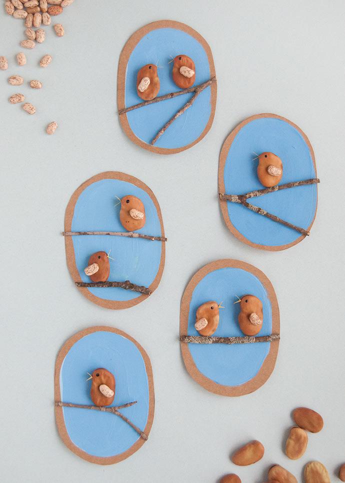 4 Crafts with birds made out of beans against blue backgrounds on a white background. 